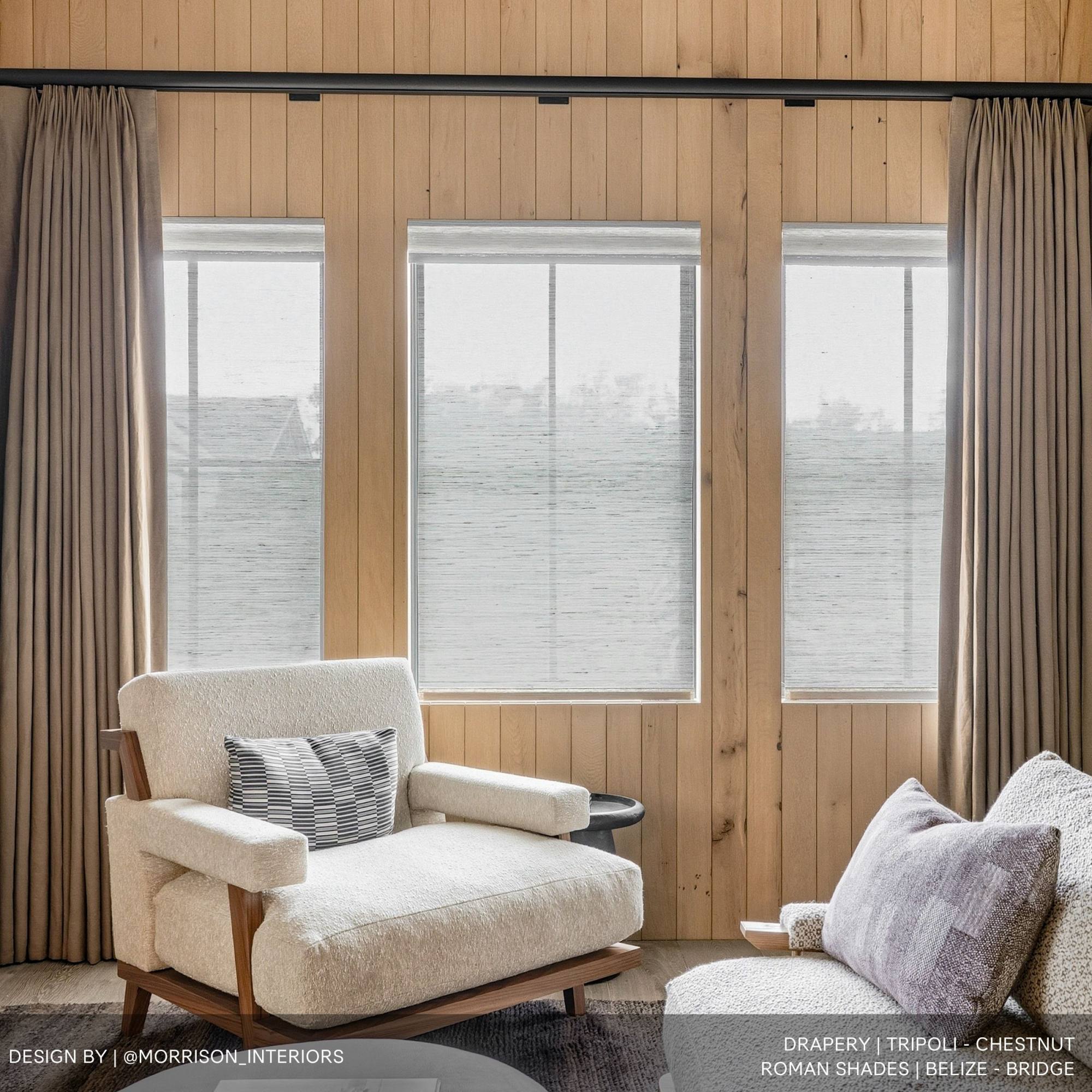 Windows with sheer shades and blackout drapery in front of it